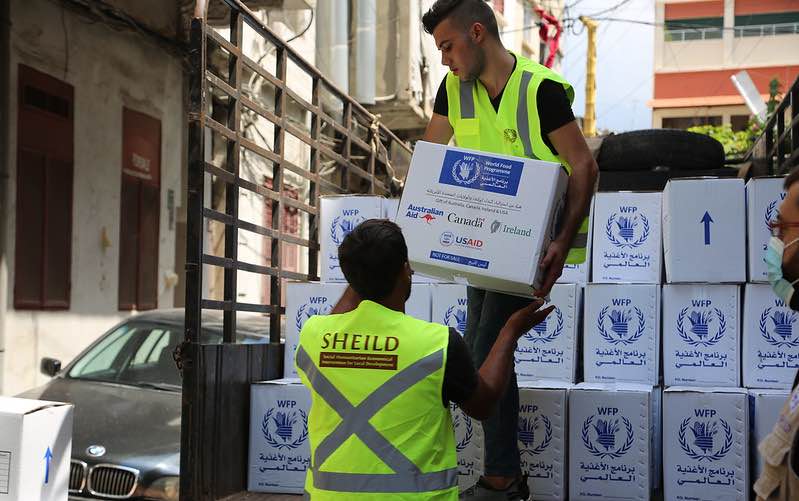 Workers unload food assistance boxes in Beirute